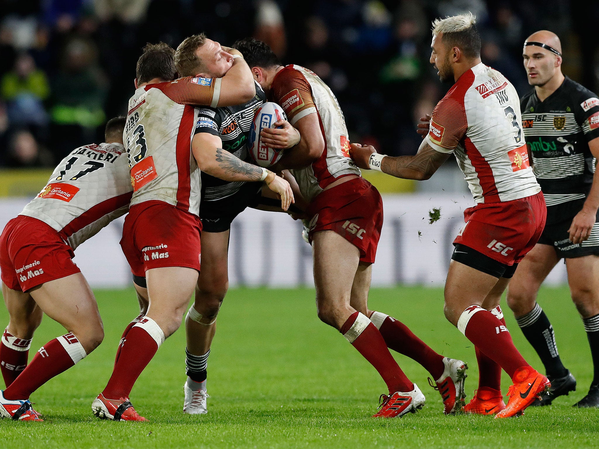 Hull FC's Josh Griffin is challenged by Catalans Dragons' Greg Bird and Justion Horo
