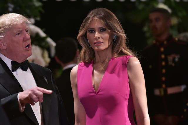 US President Donald Trump and First Lady Melania Trump arrive for the 60th Annual Red Cross Gala at his Mar-a-Lago estate in Palm Beach on 4 February 2017