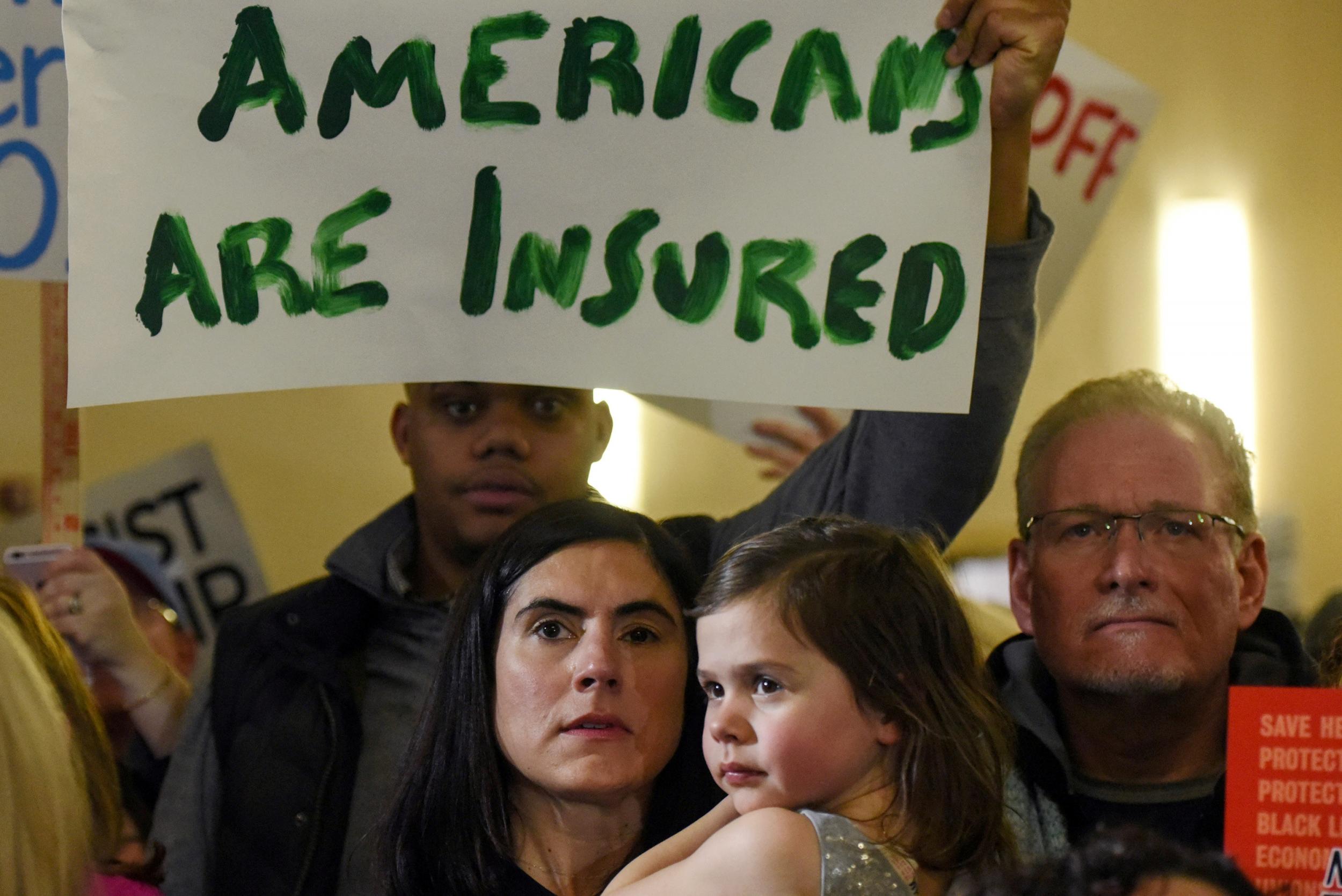 Obamacare supporters demonstrate against Donald Trump at a rally in New Jersey