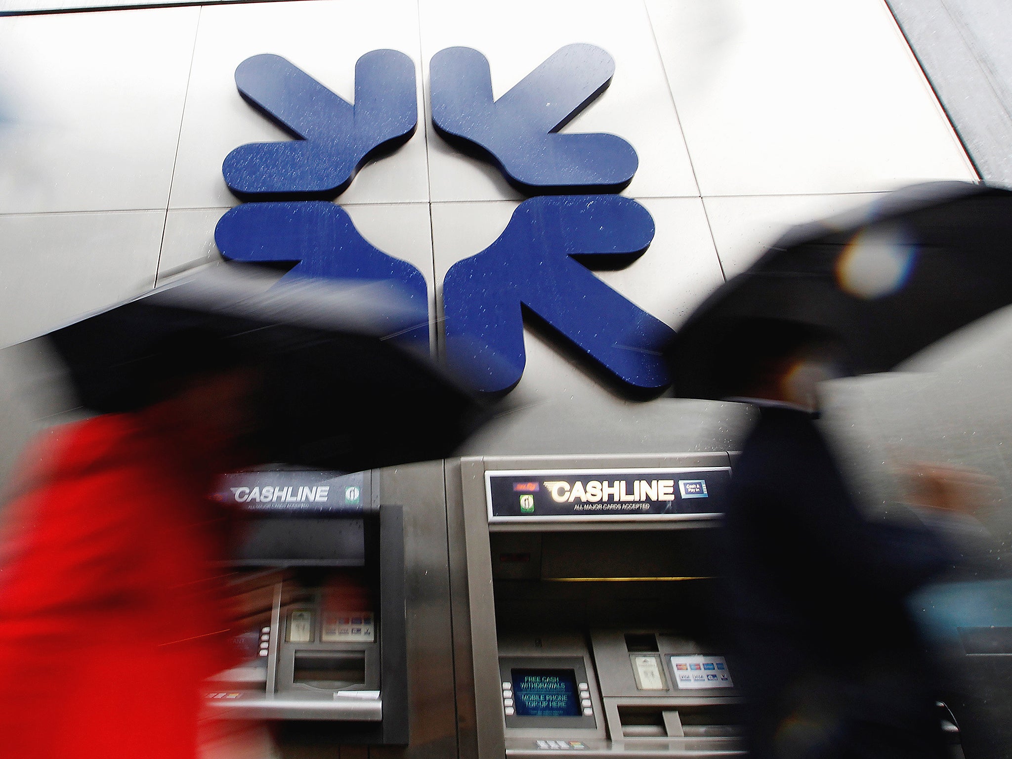 Morning commuters rush past a branch of the Royal Bank of Scotland (RBS) in London