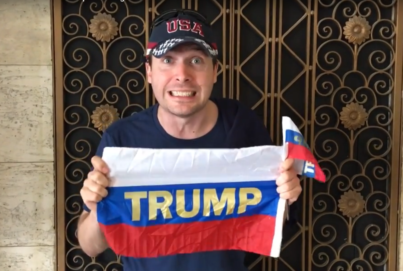 Activist poses with Russian flags which were distributed to Trump at the Conservative Political Action Conference