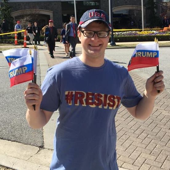 Mr Carter of Americans Take Action with flags outside the Conservative Political Action Conference (Facebook/Jason Carter)