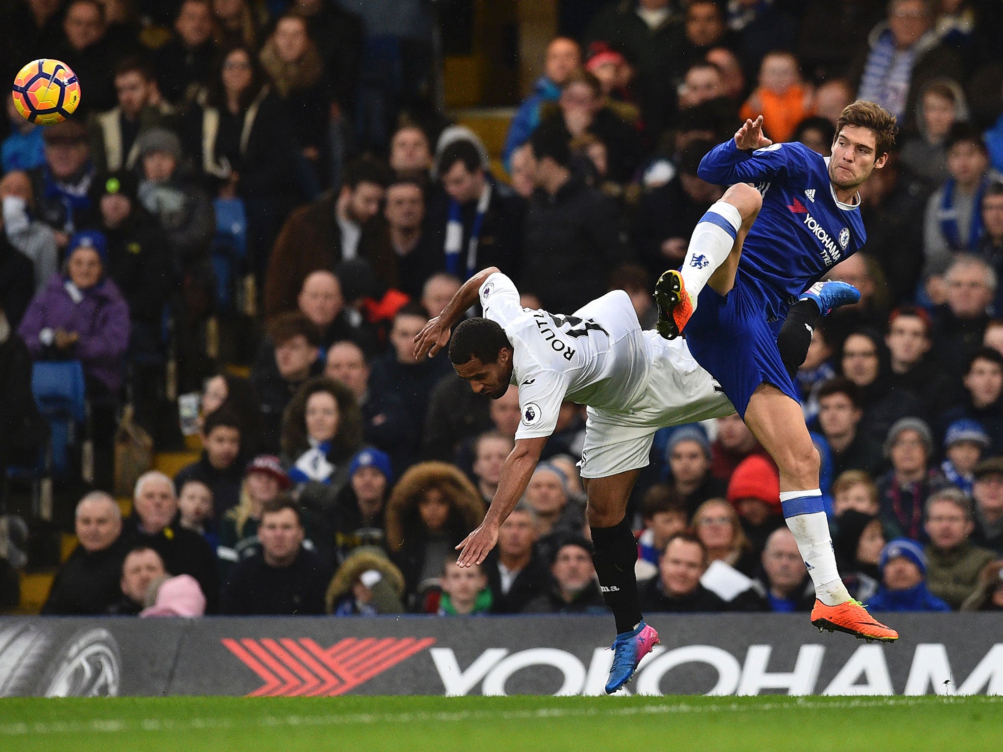 Marcos Alonso beats Wayne Routledge to the ball iin the air