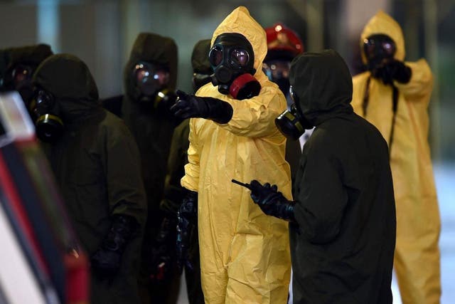 Members of Malaysia's hazmat team conduct a decontamination operation within Kuala Lumpur International Airport 2