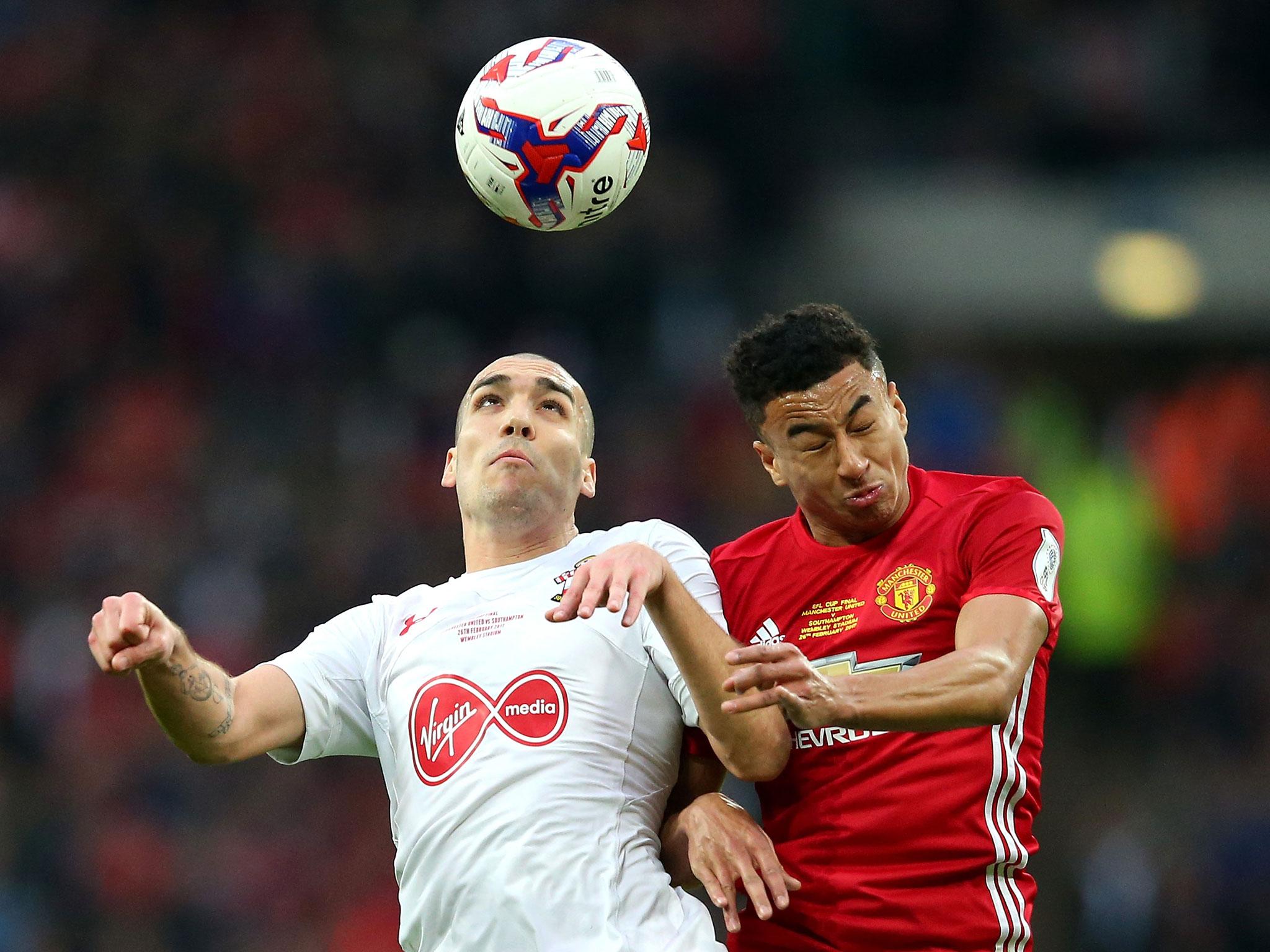 Oriol Romeu, under pressure from Jesse Lingard, rises to meet a high ball (Getty)