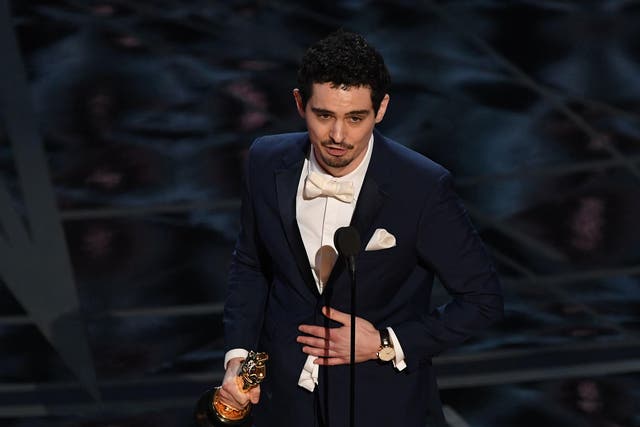 Director Damien Chazelle delivers a speech on stage after he won the Best Director award for "La La Land"at the 89th Oscars