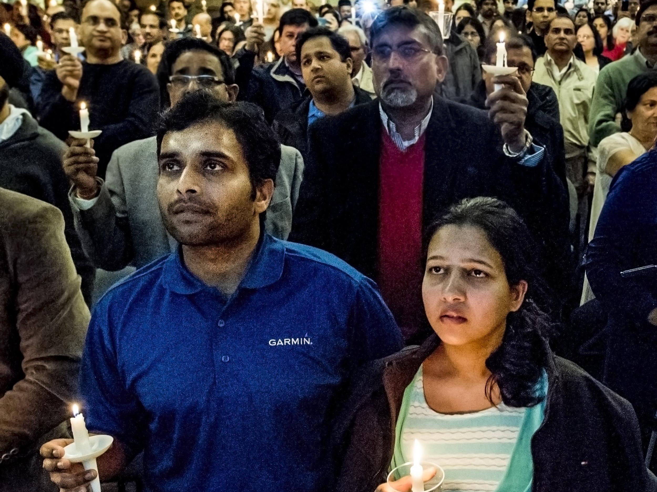 Alok Madasani, left, and his wife Reepthi Gangula hold candles during a vigil on Sunday February 26th at the Ball Conference Center in Olathe, Kansas, held in response to the deadly shooting