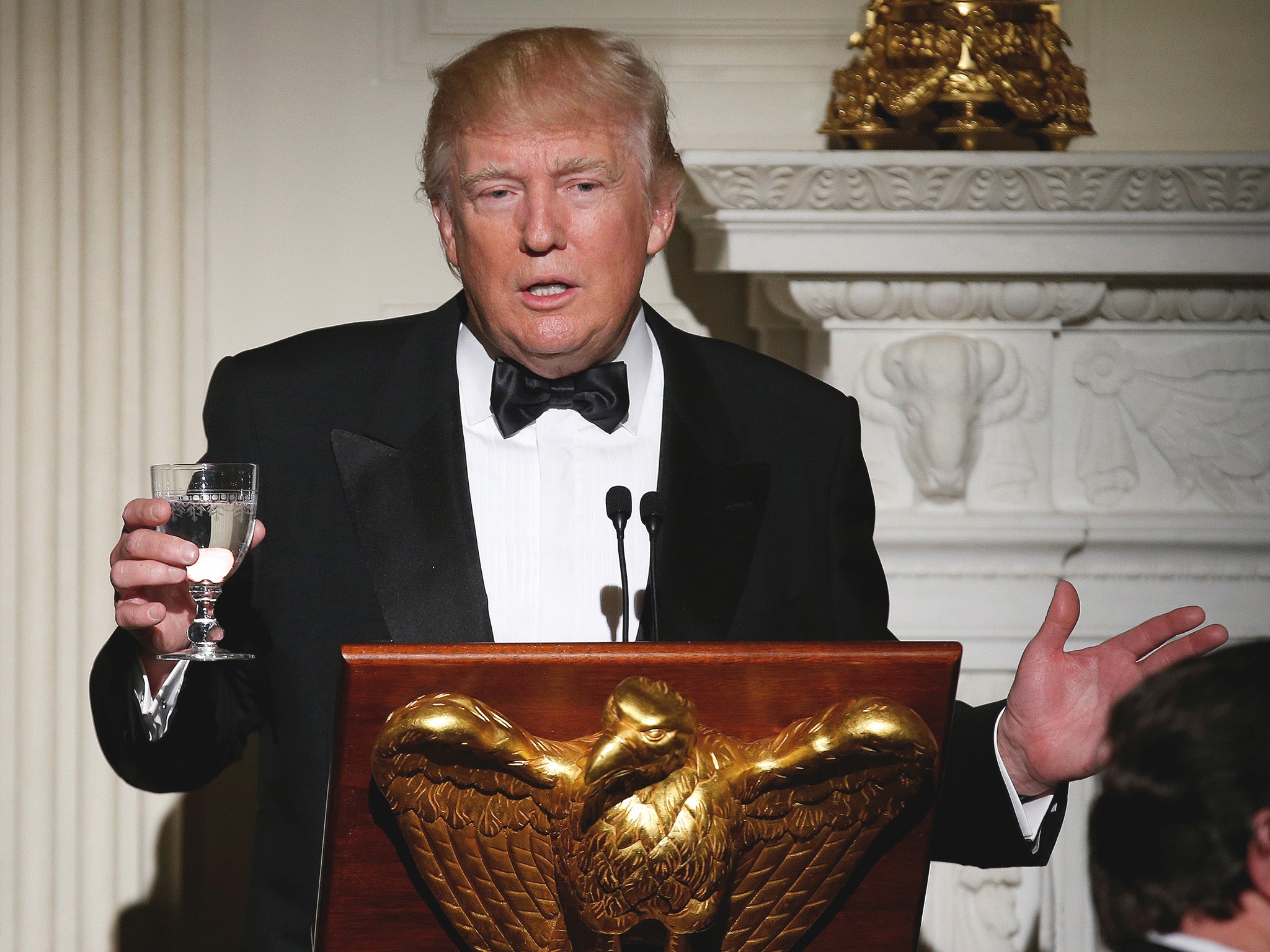 President Donald Trump makes a toast during the Governor's Ball