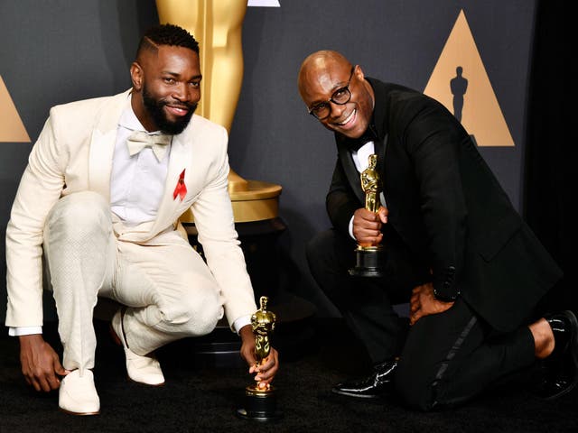 Tarell Alvin McCraney and Barry Jenkins celebrate winning Best Adapted Screenplay at the Oscars
