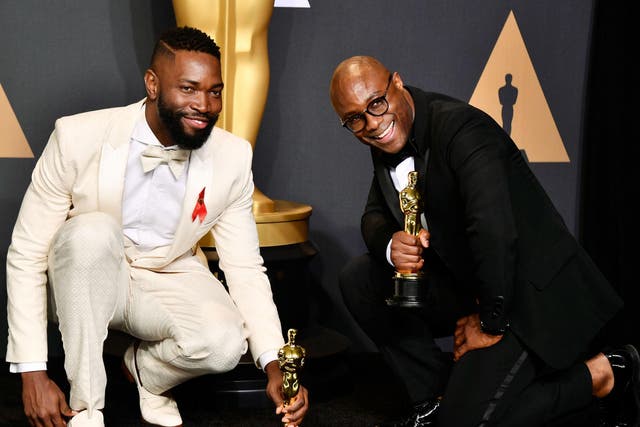 Tarell Alvin McCraney and Barry Jenkins celebrate winning Best Adapted Screenplay at the Oscars