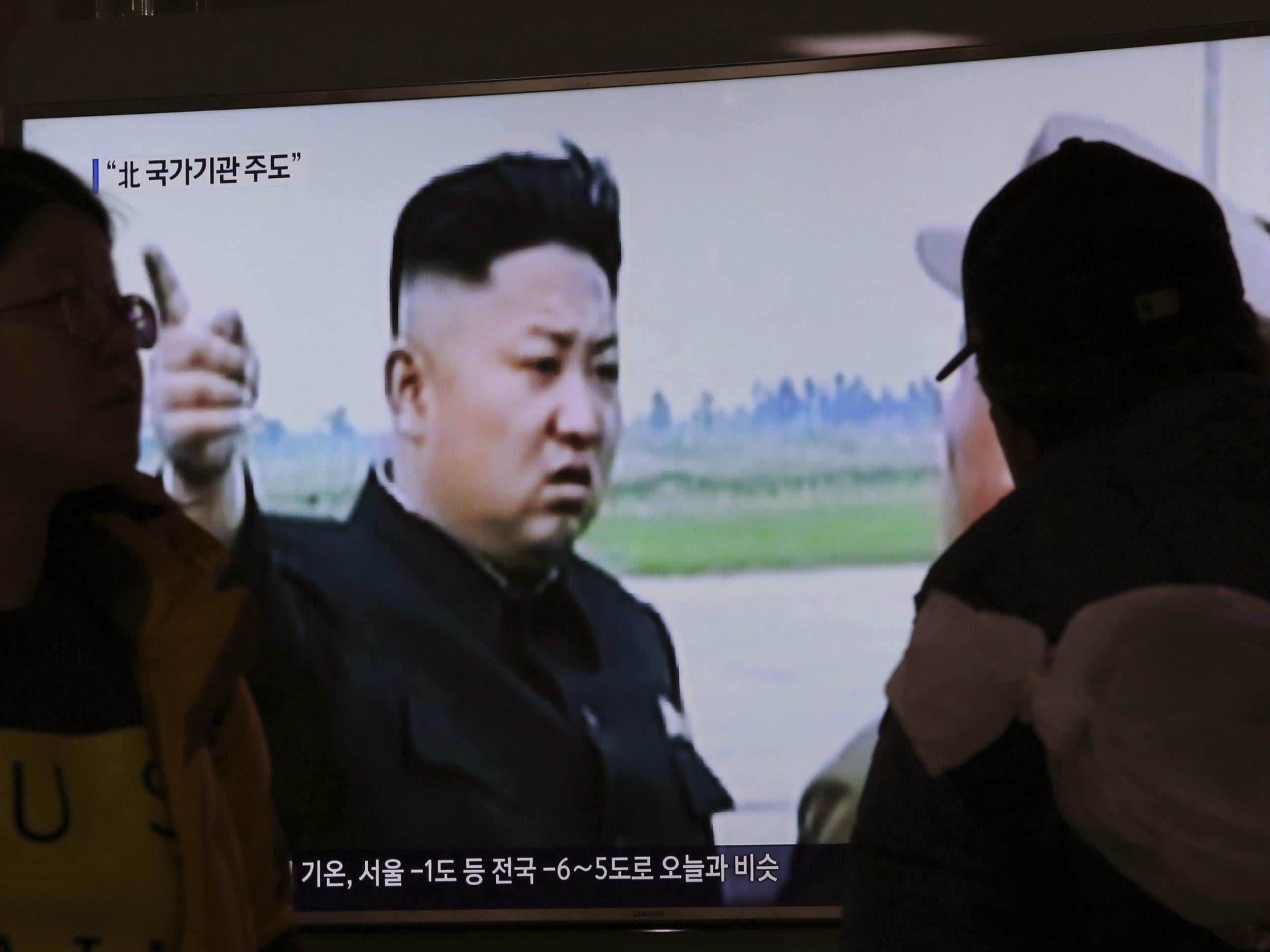 People watch a TV news programme broadcasting North Korean leader Kim Jong-un