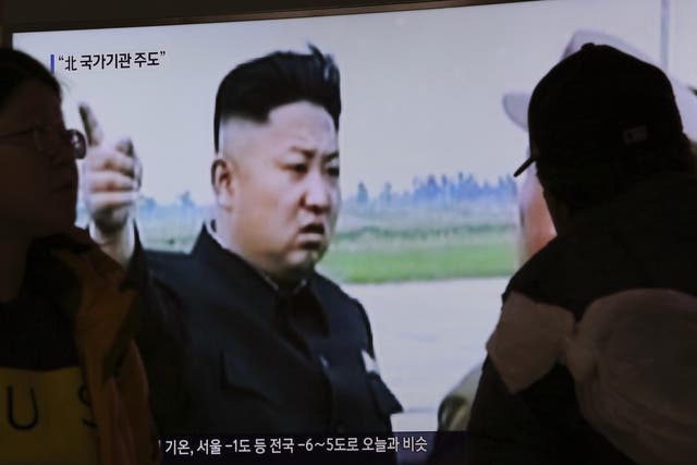 People watch a TV news programme broadcasting North Korean leader Kim Jong-un