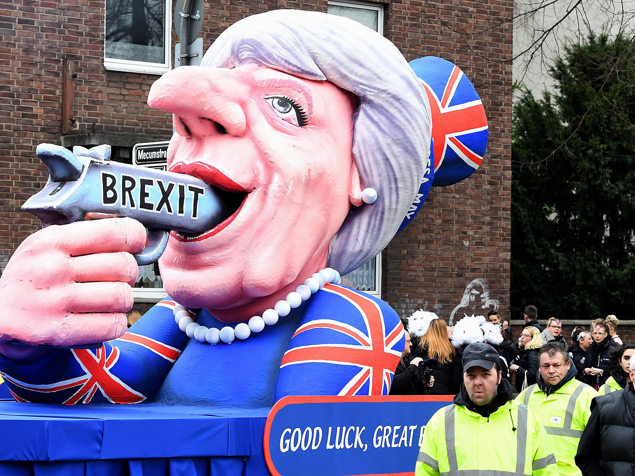 A carnival float depicting British Prime Minister Theresa May pointing a gun to her with the lettering 'Brexit' takes part in the traditional 'Rose Monday' carnival parade in Duesseldorf, western Germany
