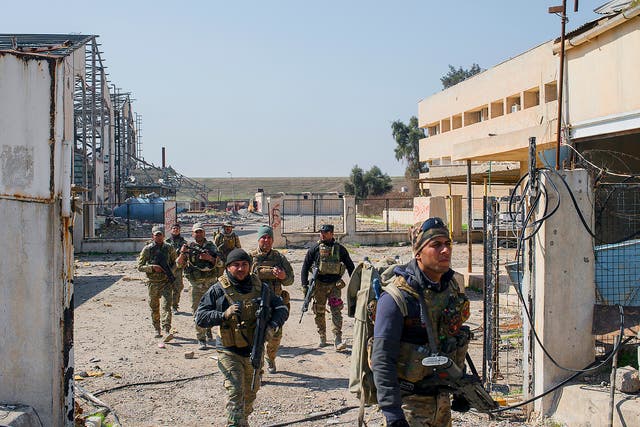 Iraqi Emergency Response Division (ERD) soldiers advance on the Islamic State occupied Mosul Airport in west Mosul, part of the offensive to retake the city some two years after it fell to the hardline jihadist group