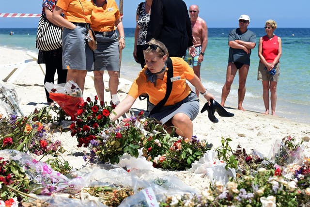Tourists lay flowers in memory of those killed by a jihadist gunman on the beach in front of the Riu Imperial Marhaba Hotel in Tunisia