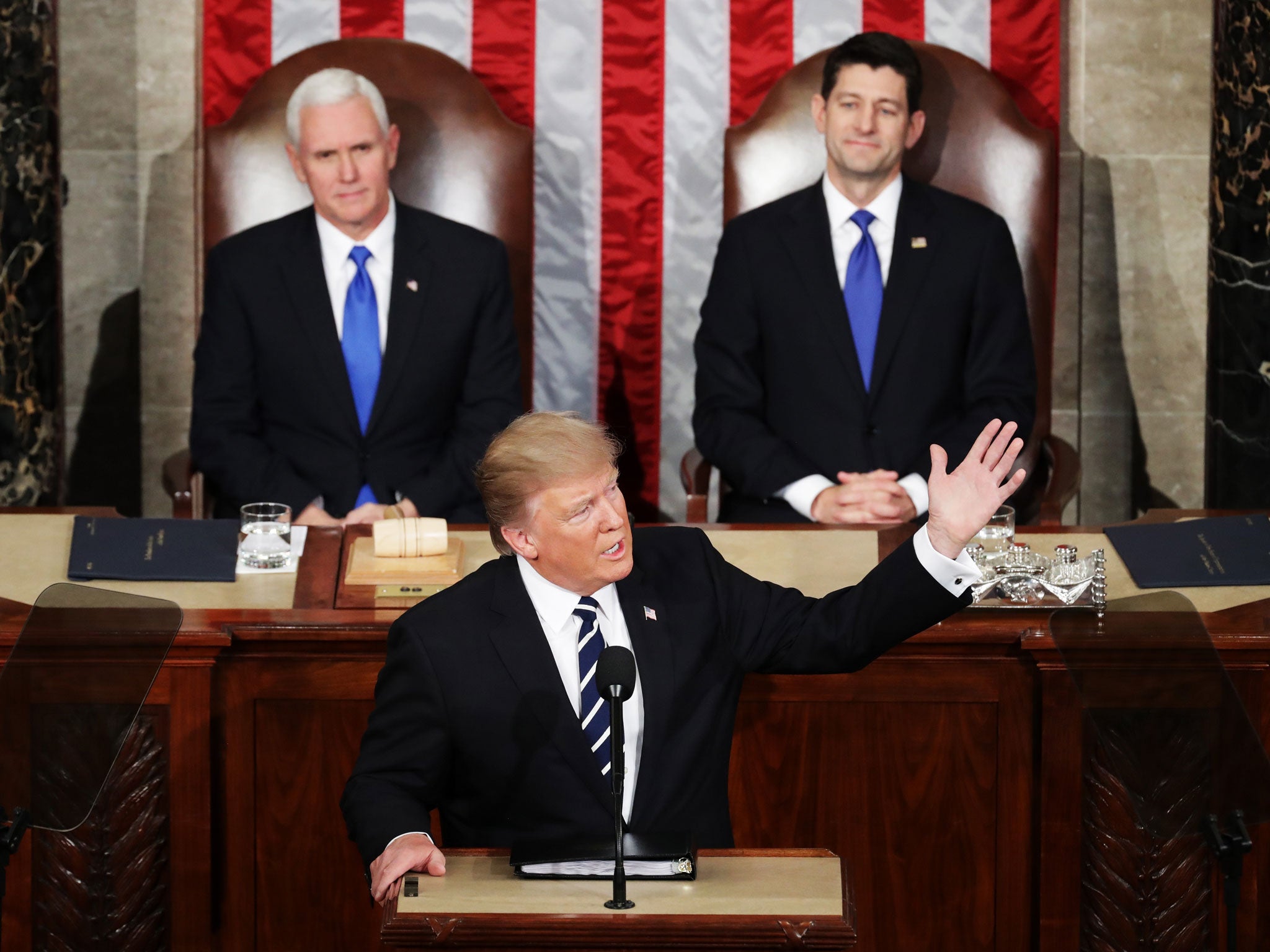 Mr Trump addresses a joint session of the US Congress as Vice President Mike Pence (left) and House Speaker Rep. Paul Ryan look on