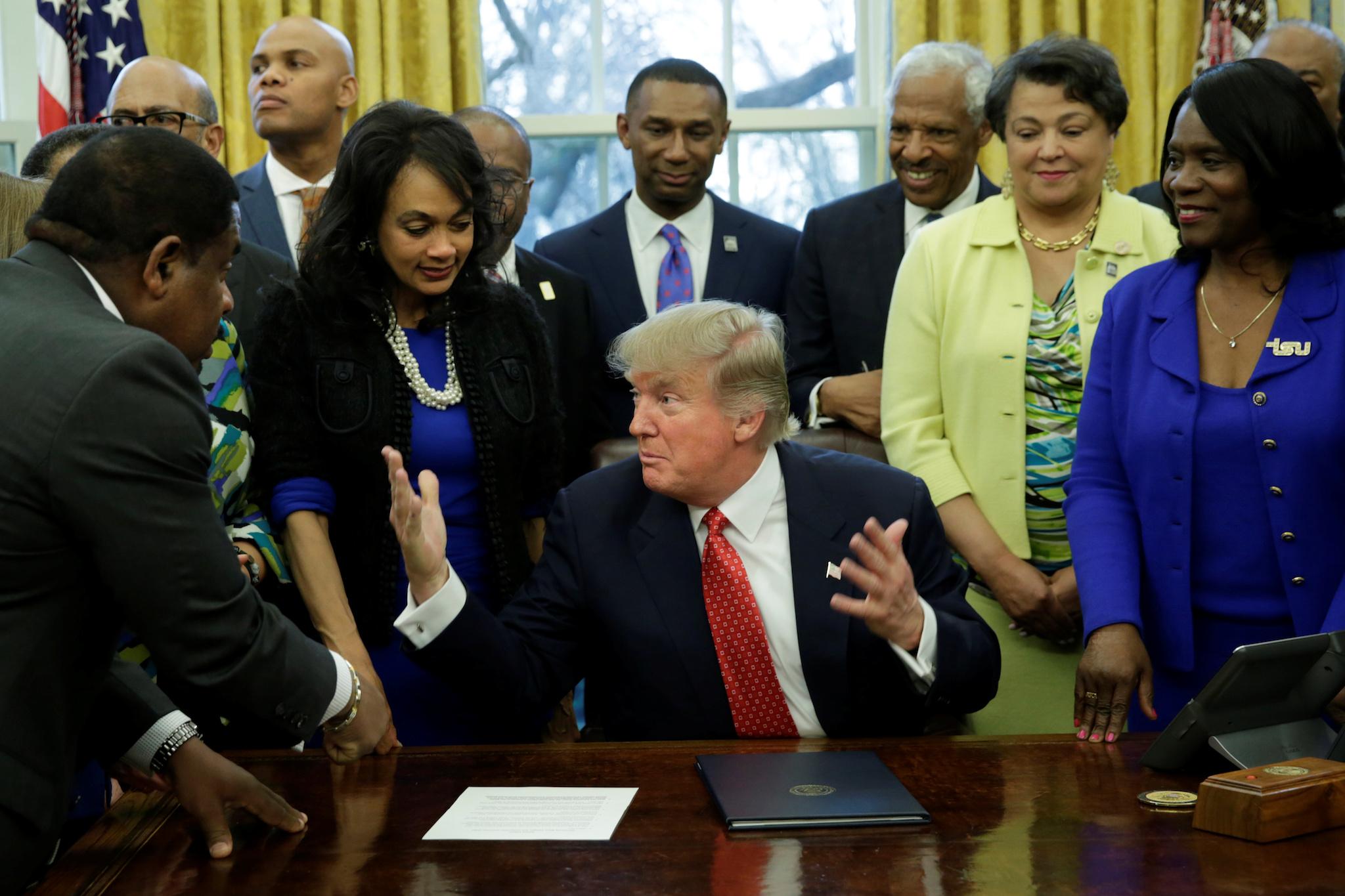 President Donald Trump talks to guests after signing the HBCU executive order in the Oval Office of the White House, in Washington, DC, U.S. February 28, 2017