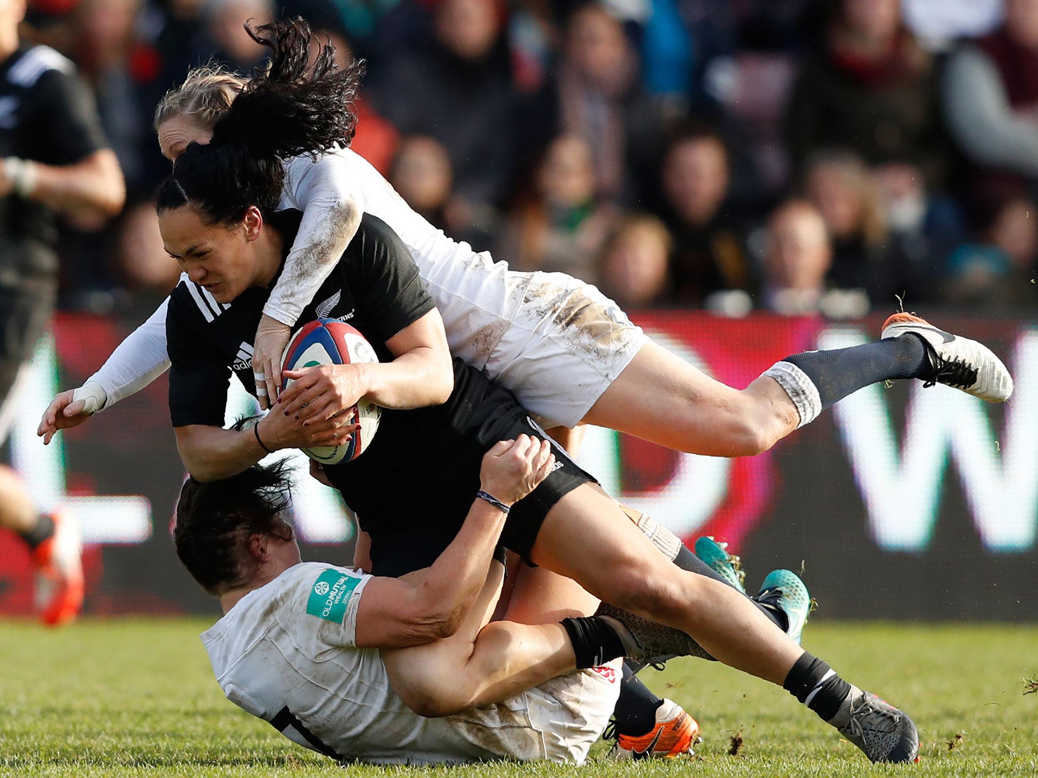 Portia Woodman of New Zealand is tackled by England's Danielle Waterman and Marlie Packer