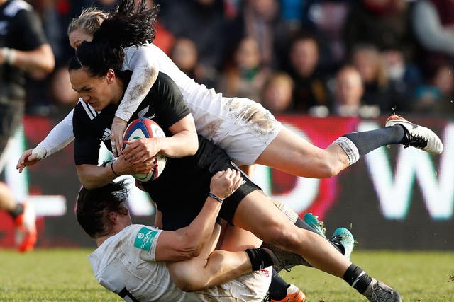 Portia Woodman of New Zealand is tackled by England's Danielle Waterman and Marlie Packer