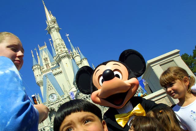 Mickey Mouse greets children in front of Cinderella's Castle at Magic Kingdom in  Florida - one of the US destinations that has seen a significant drop in flight searches