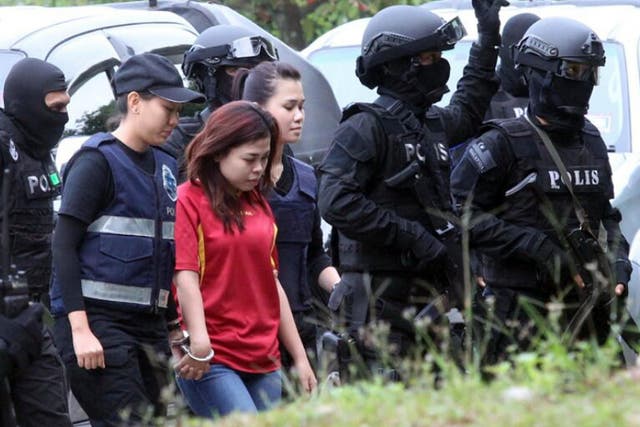 Under the protection of special forces carrying machine guns, Siti Aisyah arrives at court in Sepang, Malaysia