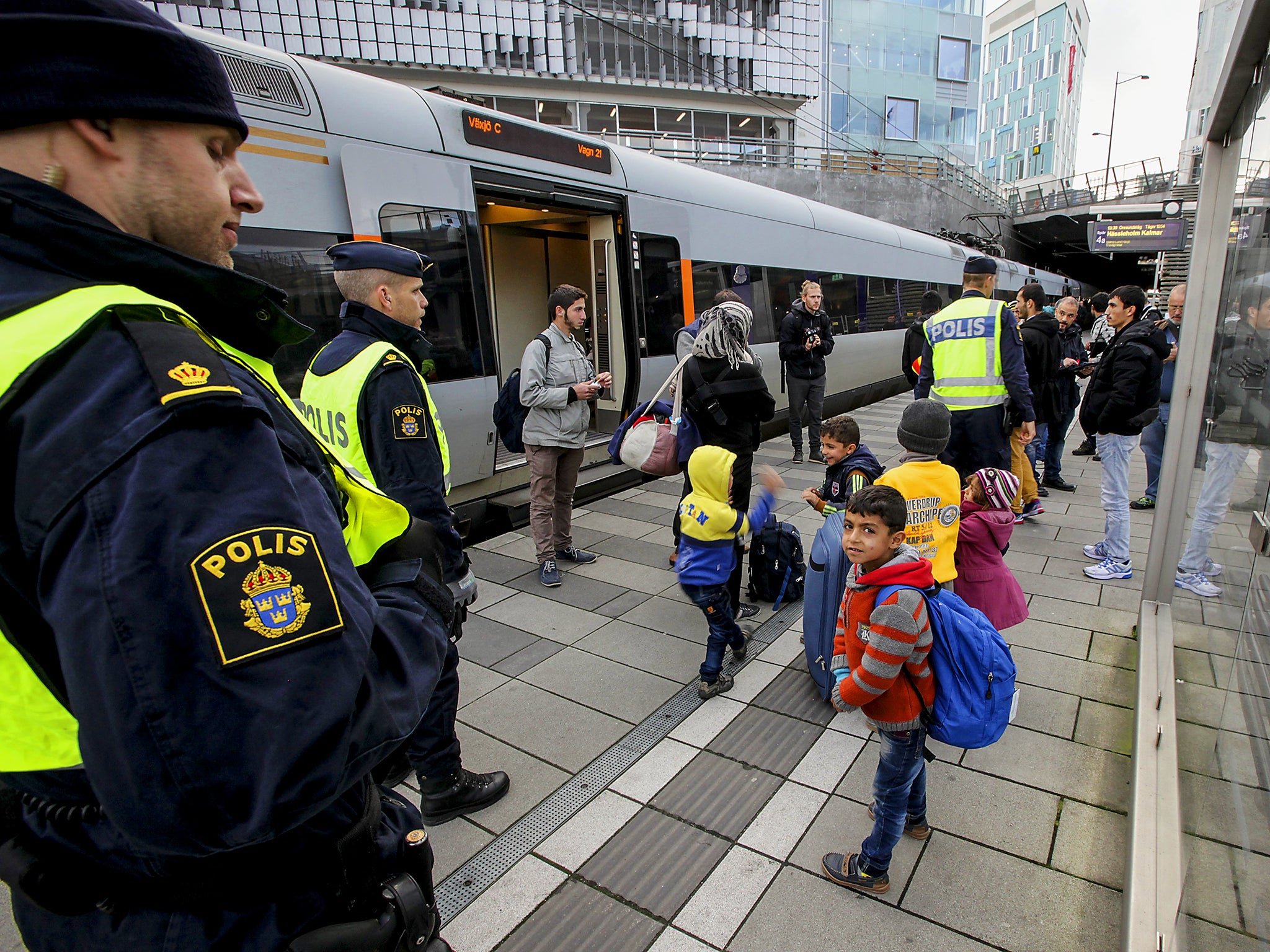 Police stand with refugee children in Sweden. The country has for years experienced the unique phenomenon of 'resignation syndrome'