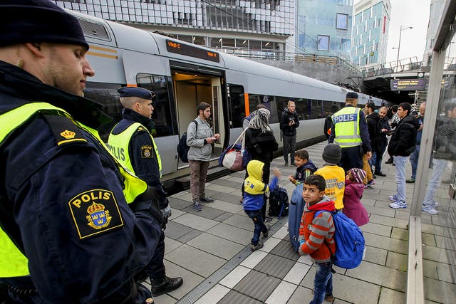 Police stand with refugee children in Sweden. The country has for years experienced the unique phenomenon of 'resignation syndrome'