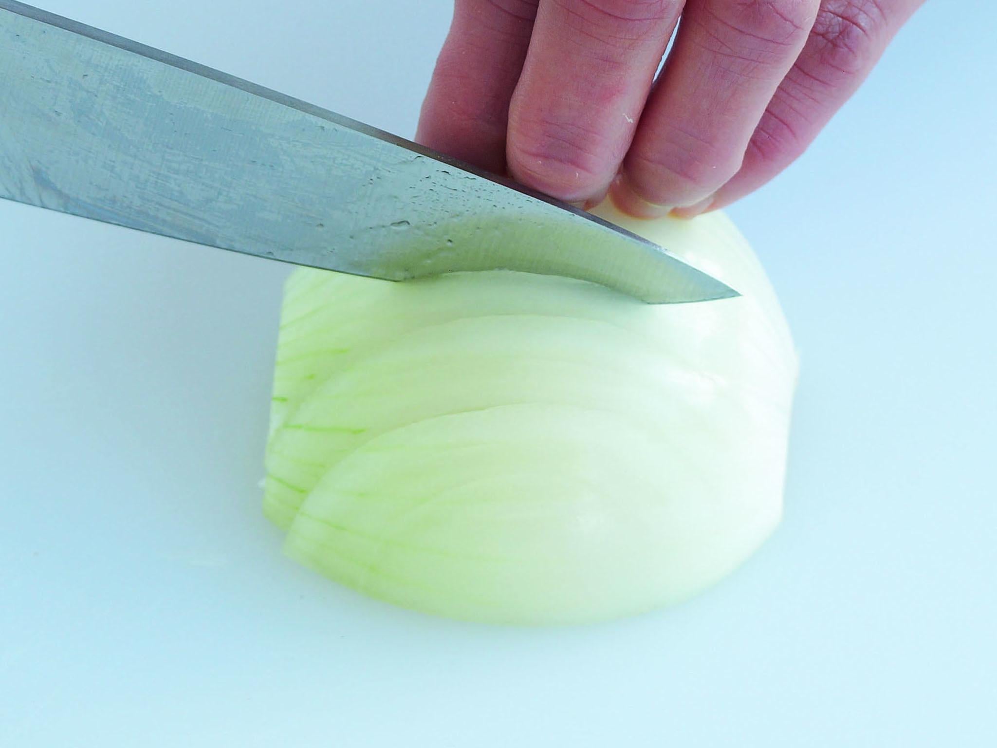 1. Halve and peel your onion. With the flat side down and the root end away from you, slice through the onion vertically, towards the root but not right through it (to keep it intact). For fine dice ensure the cuts are close together