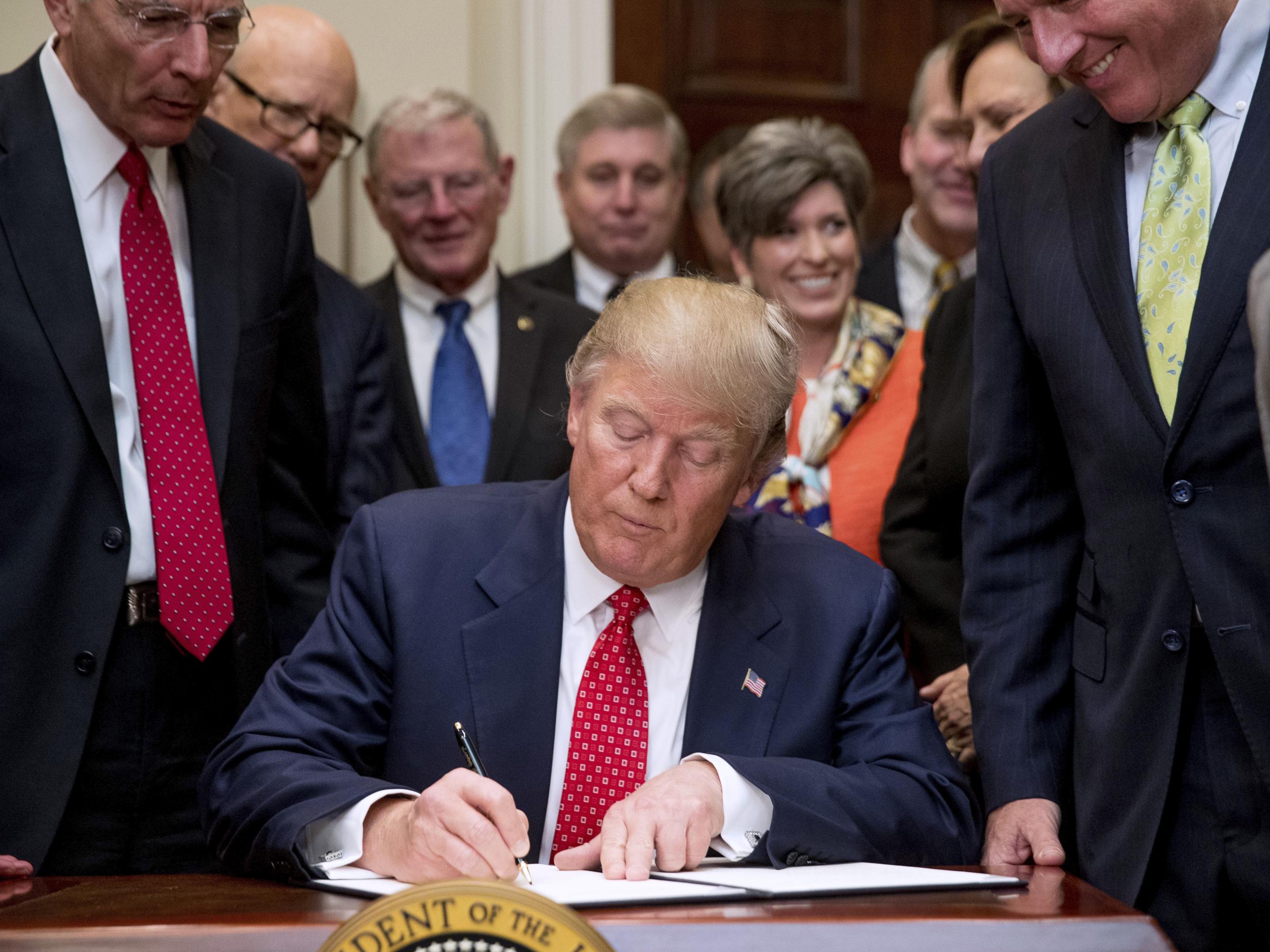 President Donald Trump signing executive orders at the White House