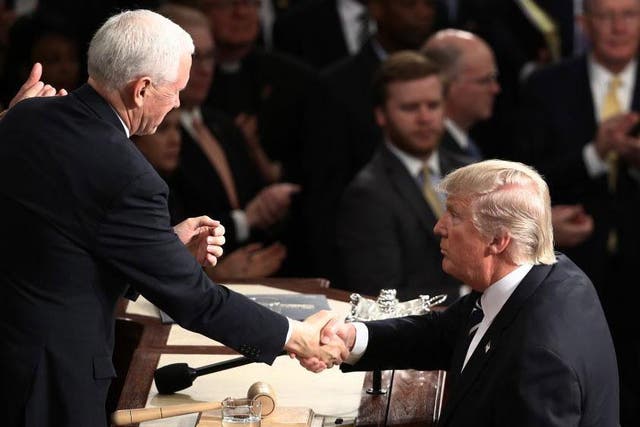 Mike Pence shakes hands with Donald Trump after The President's first speech to Congress