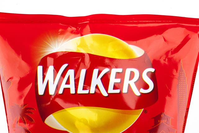 A close-up of the Walkers logo on a Ready Salted packet of crisps