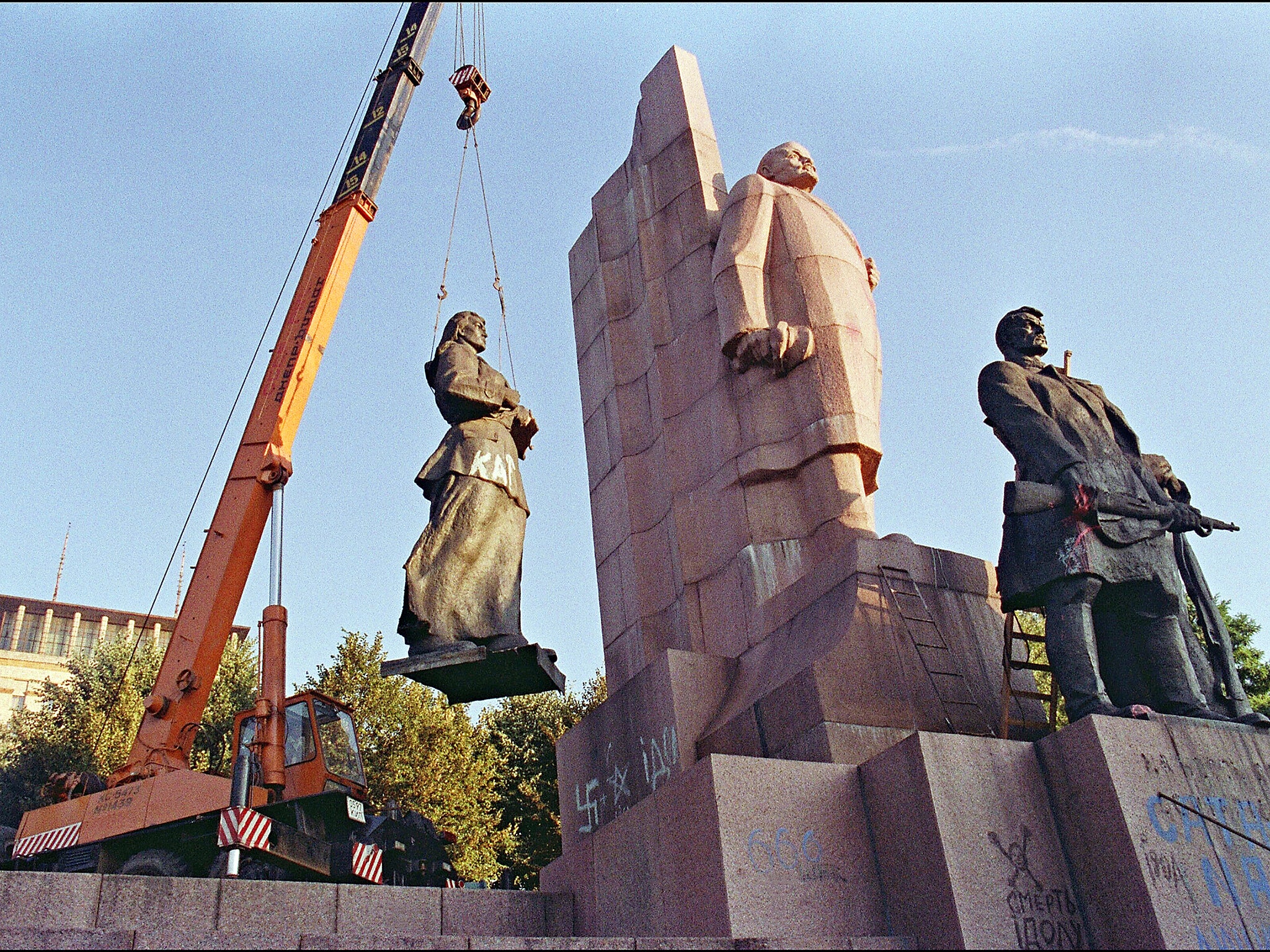 A crane manoeuvers a statue of a female worker away from the main Lenin monument in the newly named Liberty Square, formerly Lenin Square, in central Kiev.  Ukraine led the other Soviet republics in a move to secede from the Union