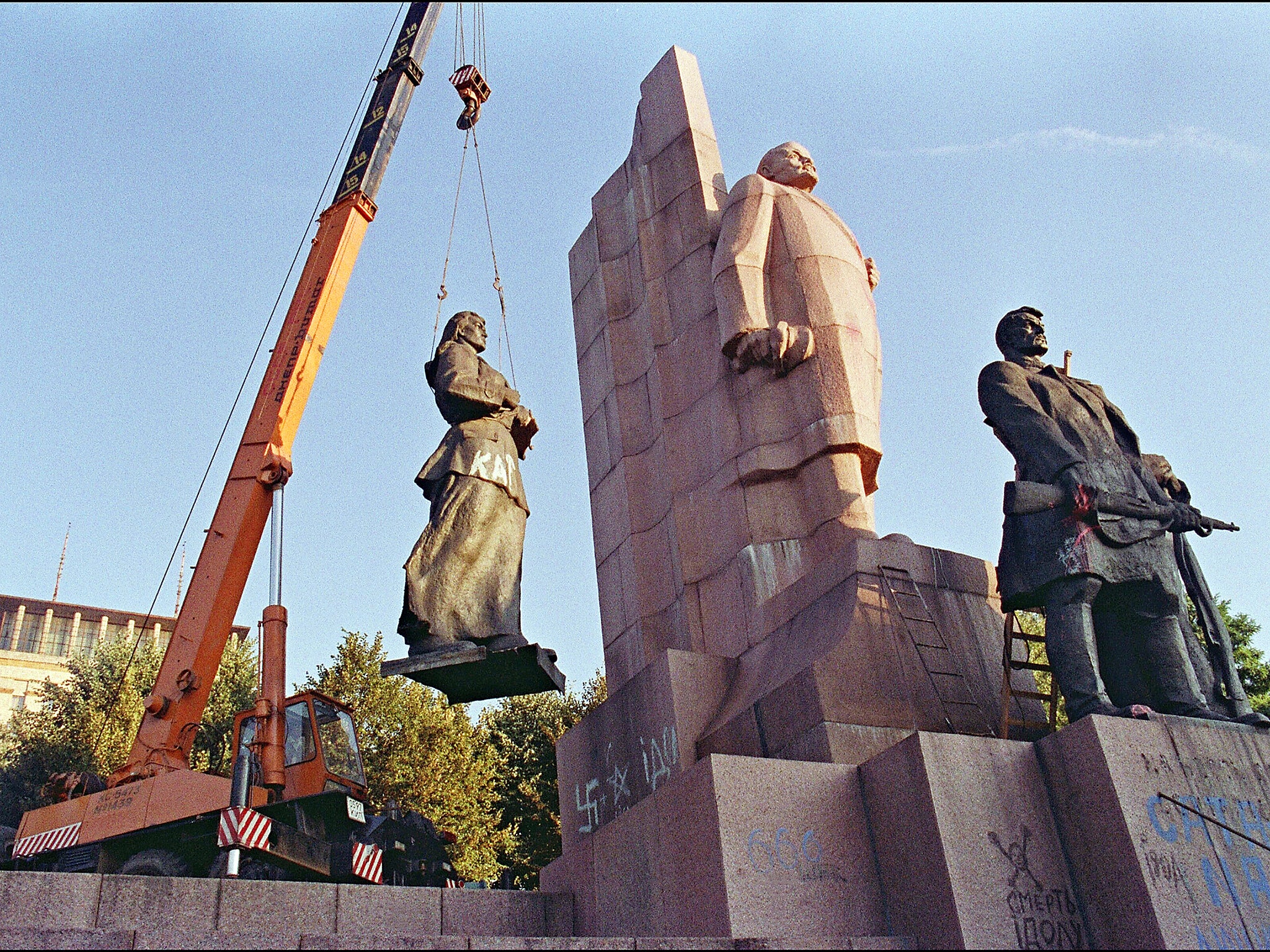 A crane manoeuvers a statue of a female worker away from the main Lenin monument in the newly named Liberty Square, formerly Lenin Square, in central Kiev. Ukraine led the other Soviet republics in a move to secede from the Union