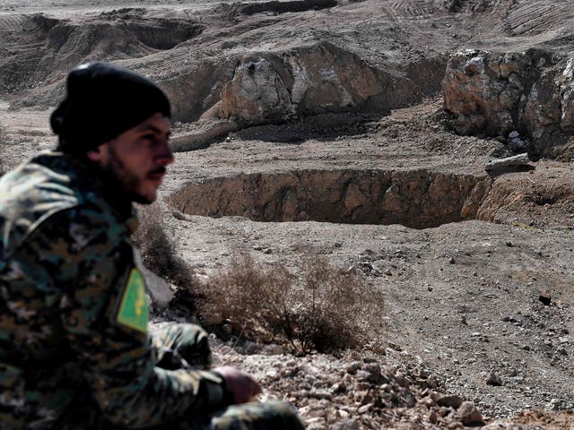 A member of the Popular Mobilisation Forces at the khasfah sinkhole and mass grave south of Mosul on 26 February