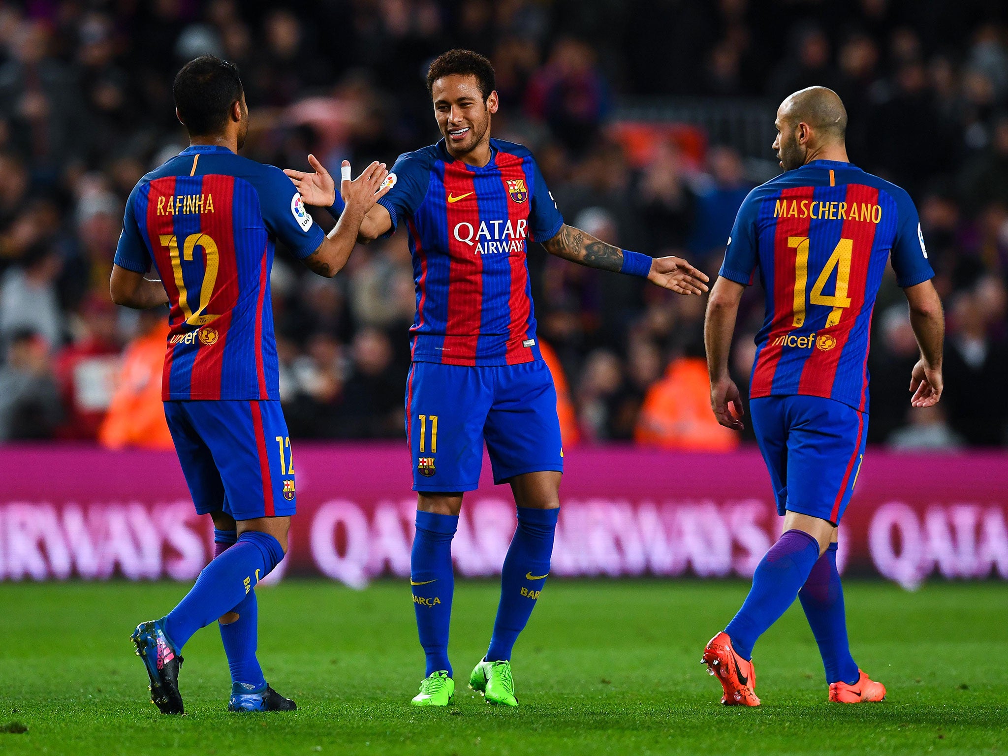Neymar celebrates with his team mates after scoring his team's fifth goal