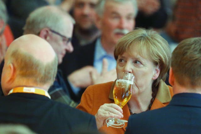 German Chancellor Angela Merkel drowns her sorrows during the political Ash Wednesday meeting of the Christian Democratic Union party in Demmin
