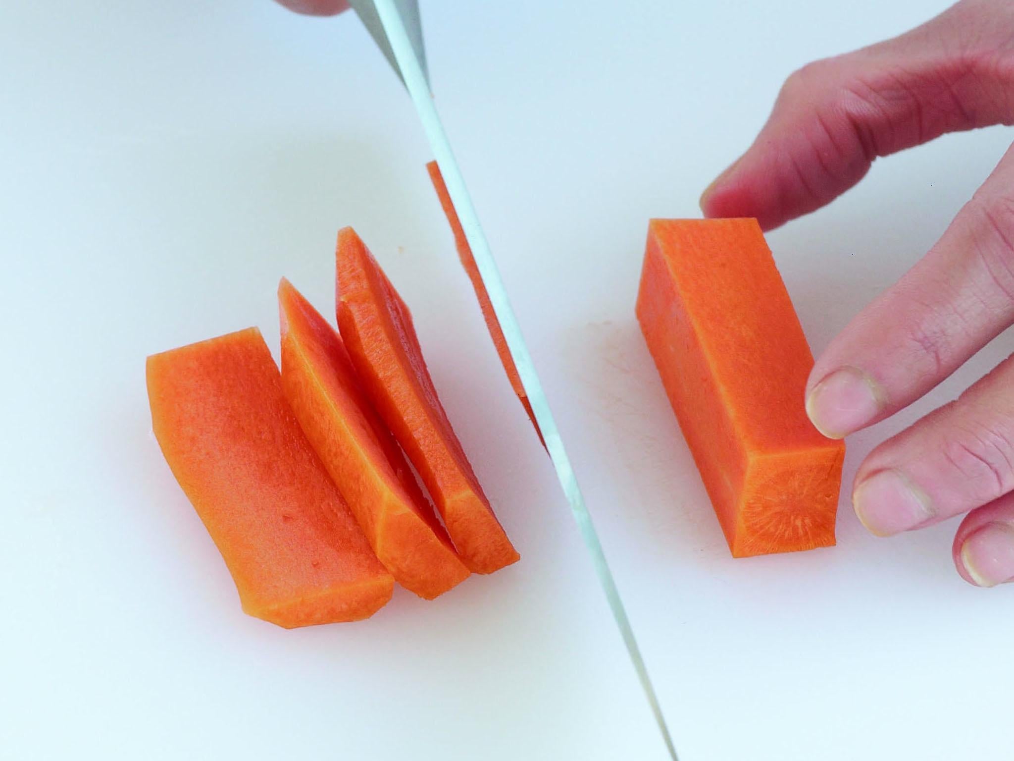 Wash and peel the carrot and trim off the top end. Cut the carrot into 4 finger-width pieces. Cut off a side of the carrot. Turn it and repeat on all other sides to create a rectangular block of carrot (Reserve any trimmings for stock)