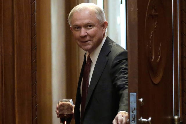 Attorney General Jeff Sessions opens a door before his first meeting with heads of federal law enforcement components at the Justice Department in Washington