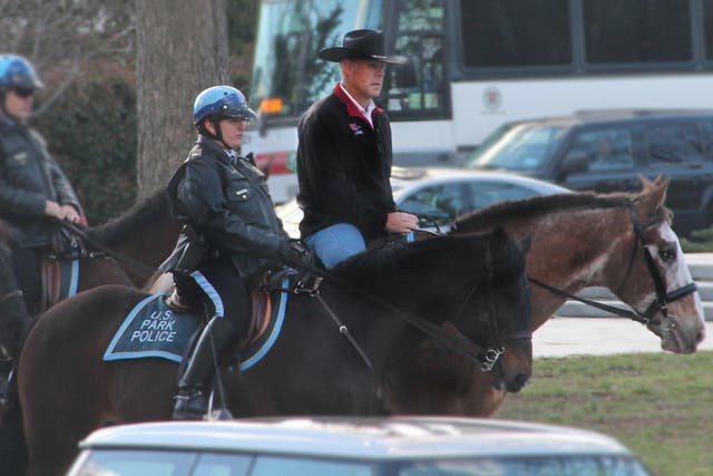 Interior Secretary Ryan Zinke arrives for work on horseback on his first day in the job