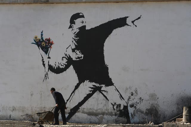 Banksy art on a building wall in Bethlehem in the West Bank