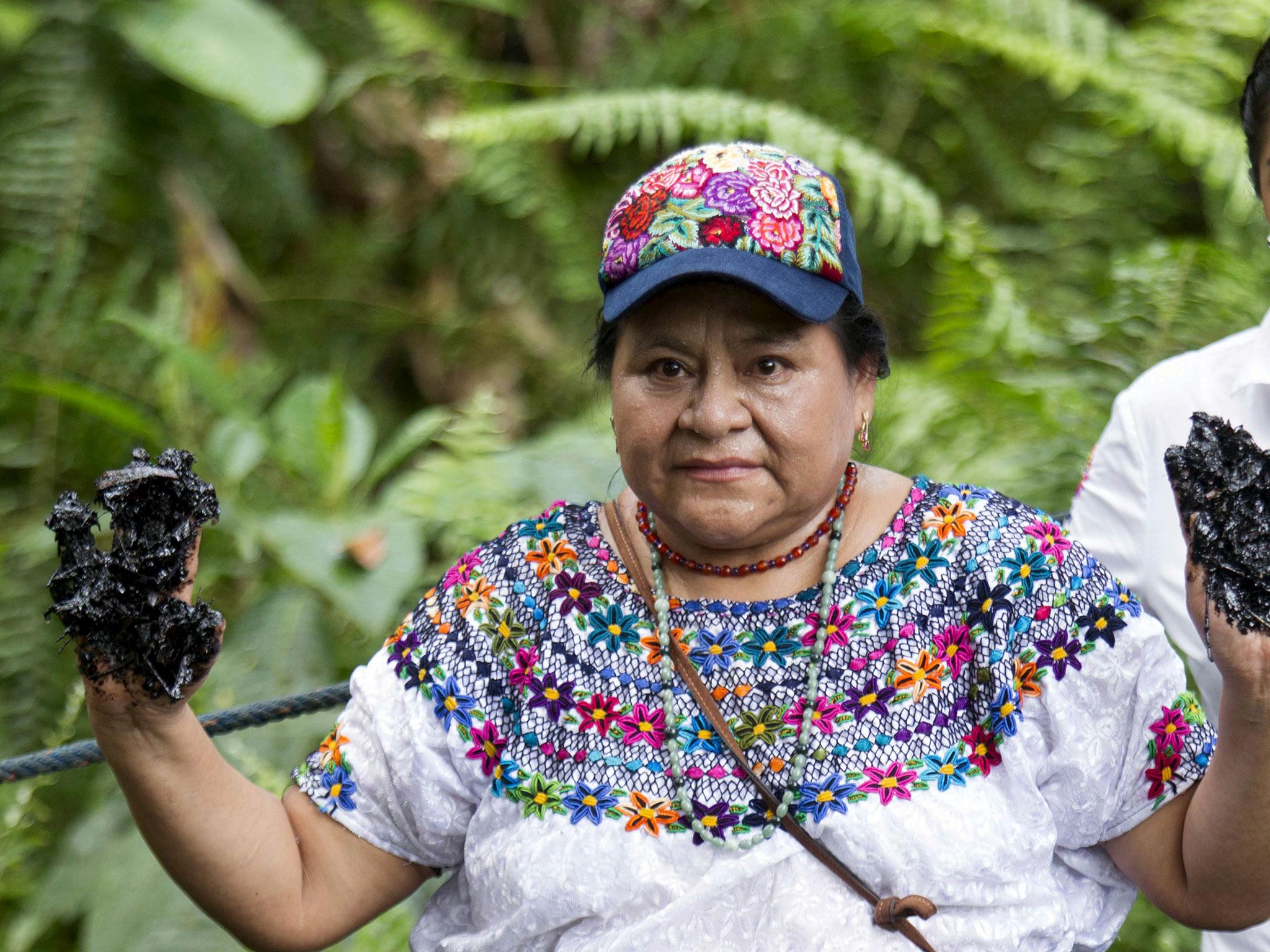 Nobel Peace Prize winner Rigoberta Menchu, an indigenous people’s rights activist, shows her hands covered with oil during a protest in Lago Agrio in Ecuador near the site of oil exploration by Chevron’s Texaco subsidiary
