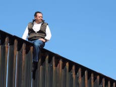 Mexican politician climbs border wall to make point about Trump policy