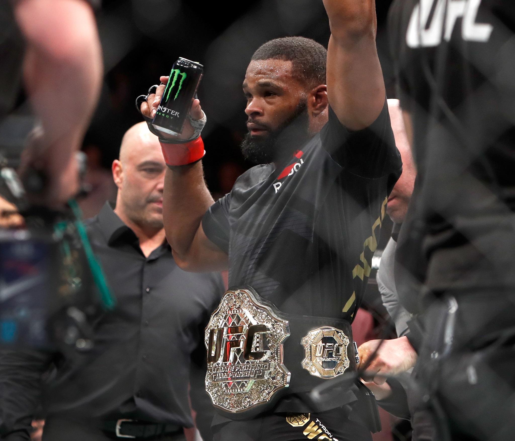 &#13;
Woodley celebrates retaining his welterweight title (Getty)&#13;