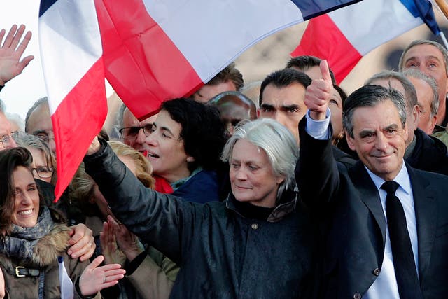François Fillon, next to his wife Penelope, speaks at a rally in Paris on Sunday