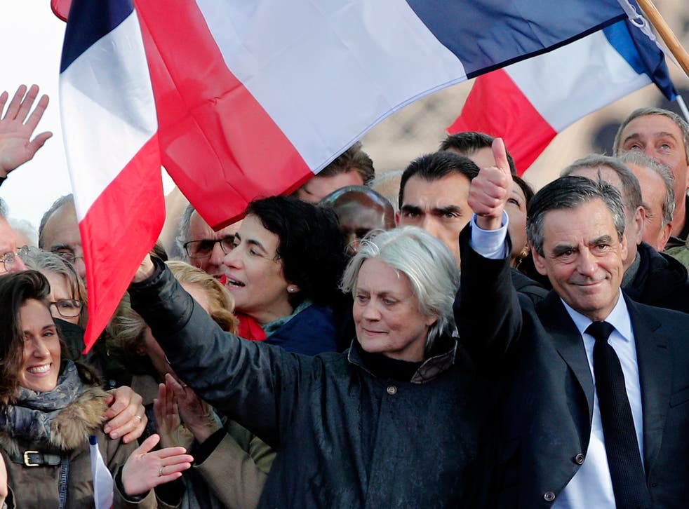 François Fillon, next to his wife Penelope, speaks at a rally in Paris on Sunday