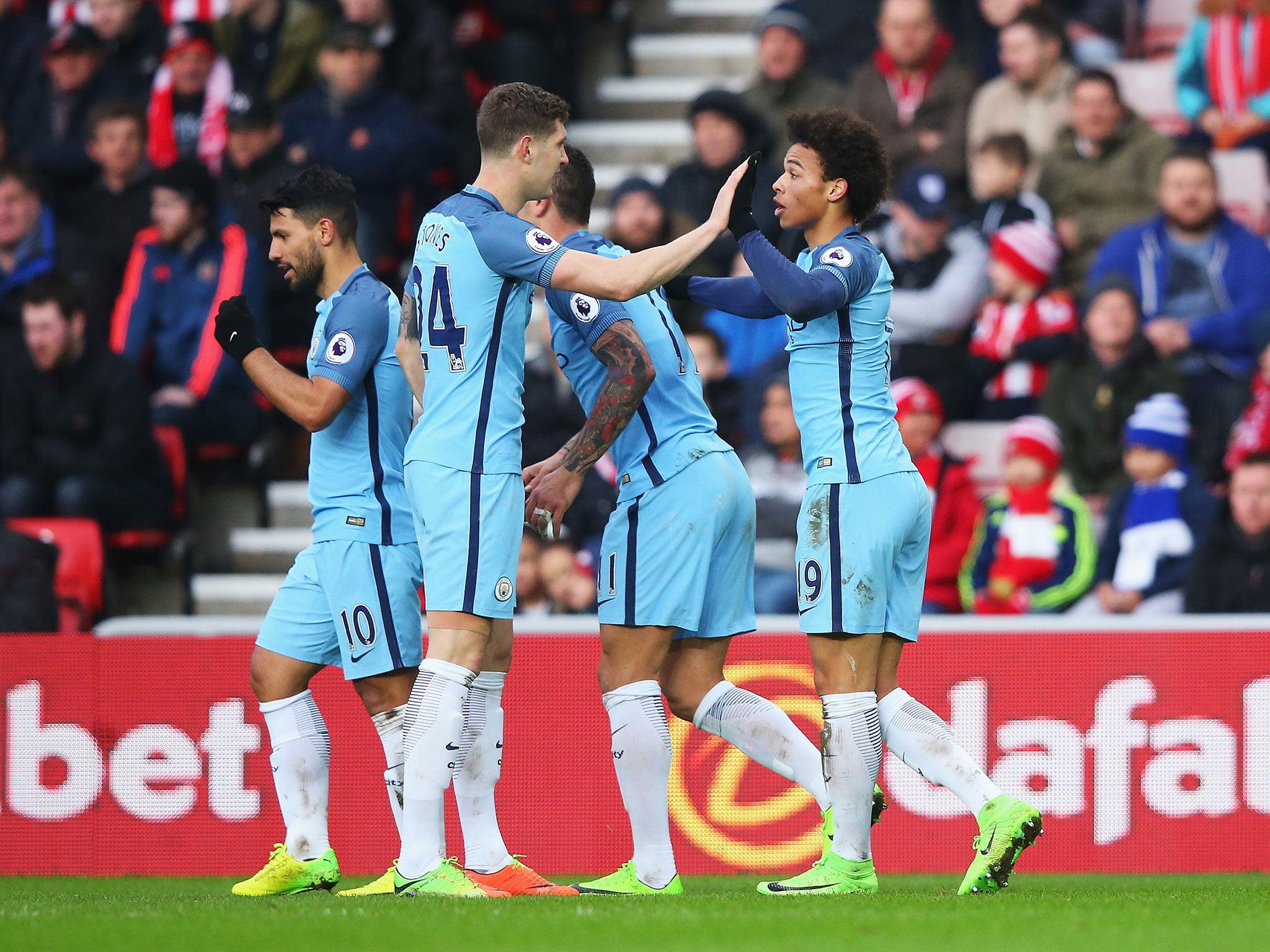 Leroy Sane celebrates with team-mates after scoring for his side