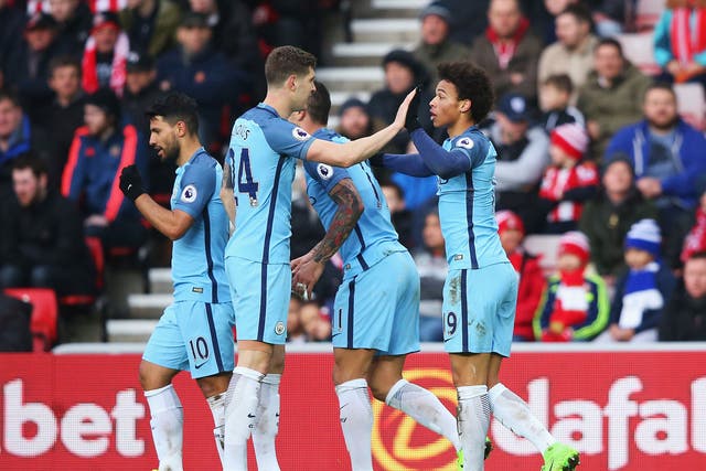 Leroy Sane celebrates with team-mates after scoring for his side