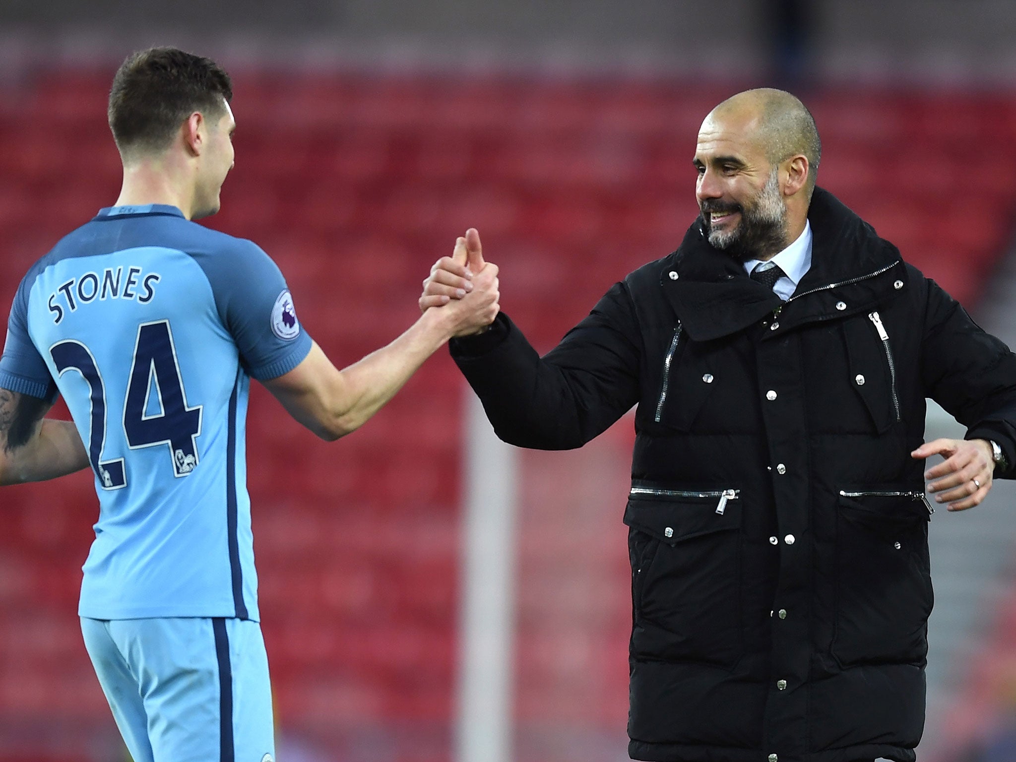 Guardiola with John Stones after the final whistle