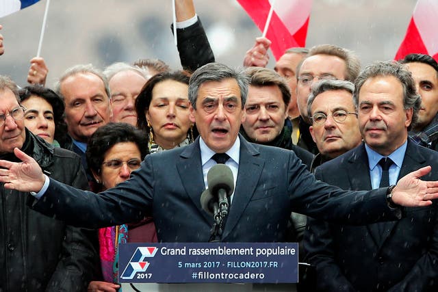 French conservative presidential candidate Francois Fillon urges his supporters not to "give up the fight" for the presidency during a rally in Paris.