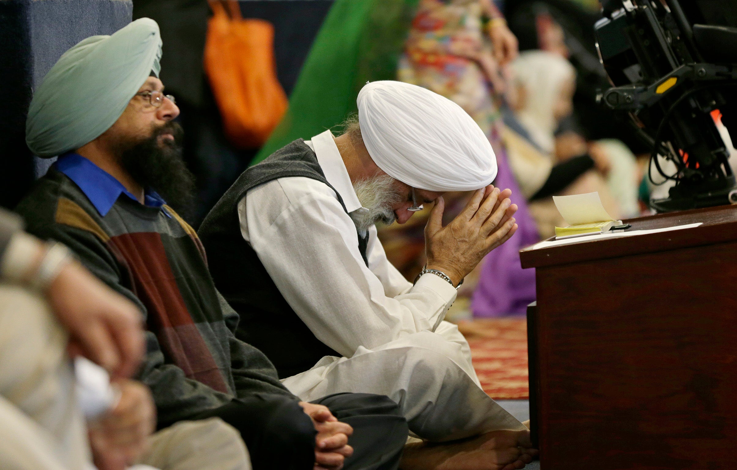 A Sikh man bows his head as he attends the Gurudwara Singh Sabha of Washington near where a member of his community was shot on his driveway